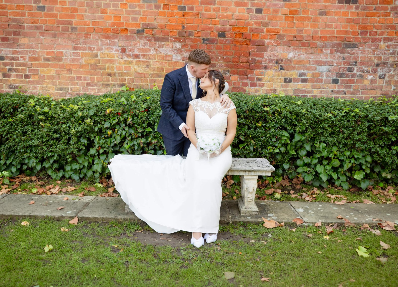 Bride and groom sharing a quiet moment on a garden bench