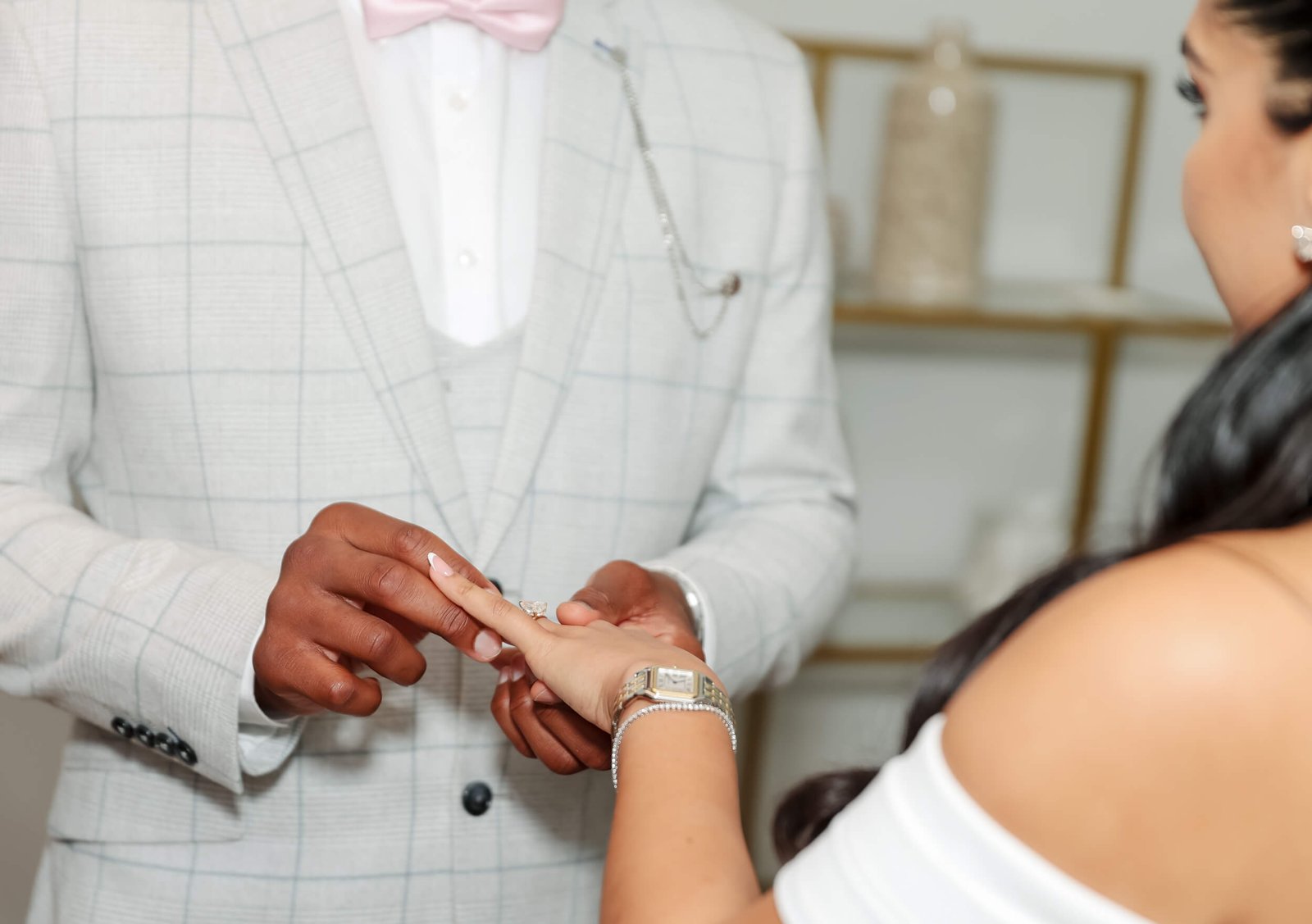 Close-up of a groom placing a wedding ring on his bride's finger
